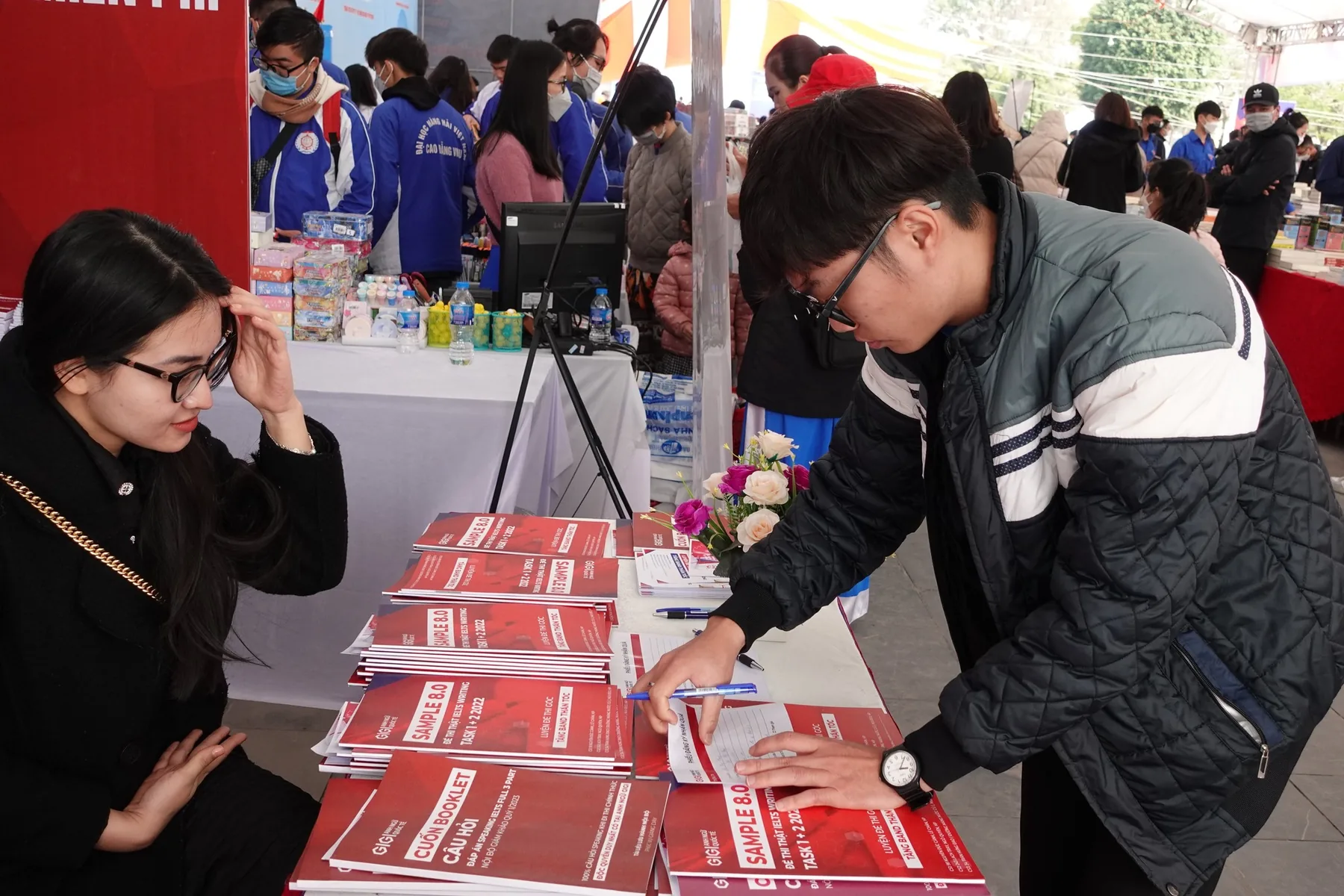 Students at the stall handing out the programme booklets.