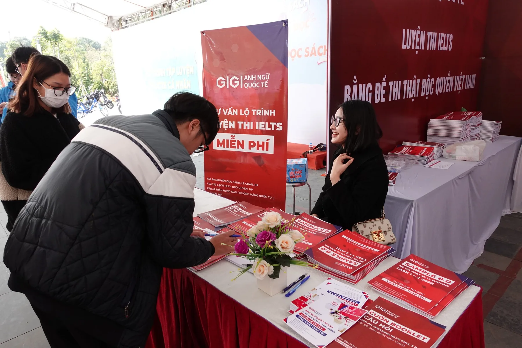 The GIGI English stall offering free IELTS practice papers.